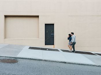 Full length of young couple walking in city