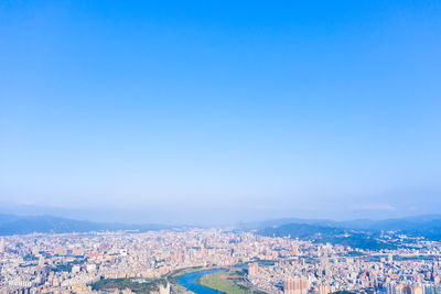 High angle shot of townscape against clear blue sky