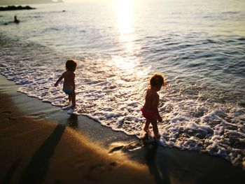 Rear view of women on beach