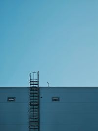 Low angle view of building against clear blue sky