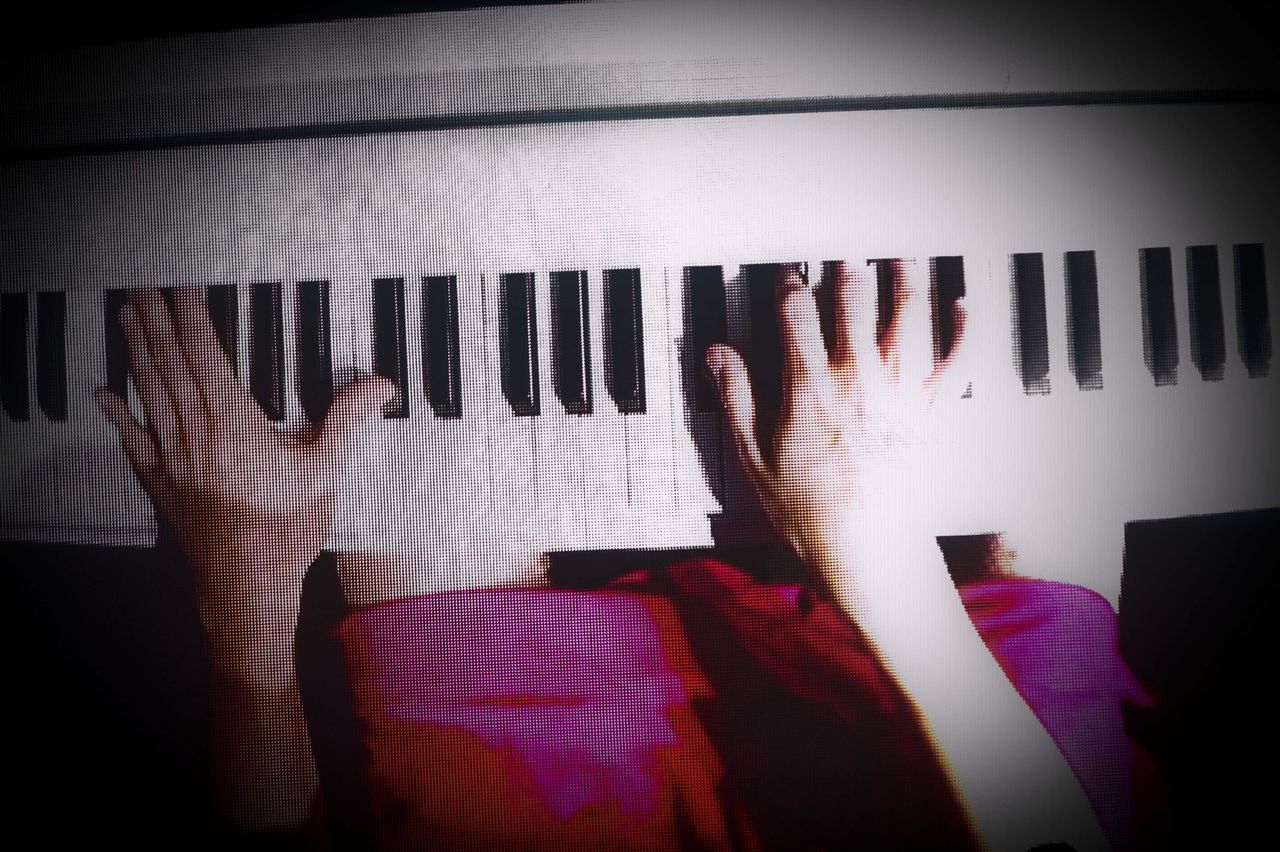 HIGH ANGLE VIEW OF WOMAN PLAYING PIANO AT NIGHT