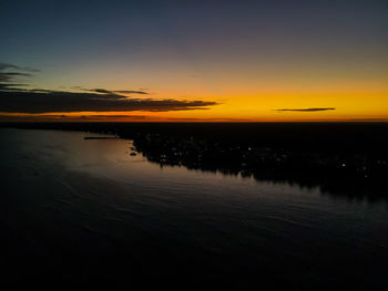 Scenic view of lake against romantic sky at sunset