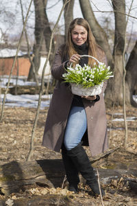 Portrait of smiling young woman standing outdoors