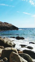 View of calm beach against blue sky