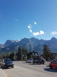 Cars on road against blue sky