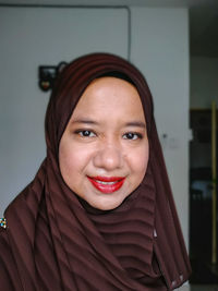 Close-up portrait of smiling young woman