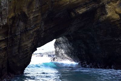 Scenic view of sea seen through cave