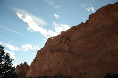 Low angle view of rocky mountains against sky