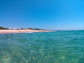 Scenic view of calm sea against clear sky