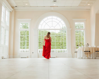 Portrait of woman standing in corridor