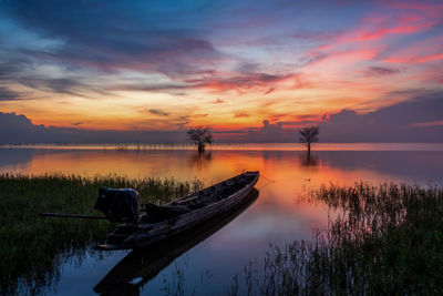 Scenic view of lake against sky during sunset