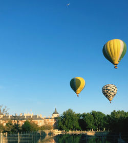 Low angle view of hot air balloons against clear sky