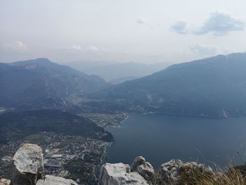 Scenic view of sea and mountains against sky