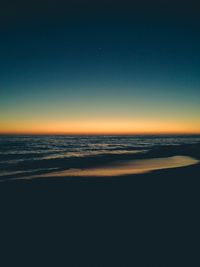 Scenic view of sea against clear sky during sunset