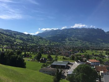 Scenic view of village and houses against sky