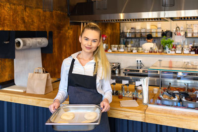 Young woman standing at cafe