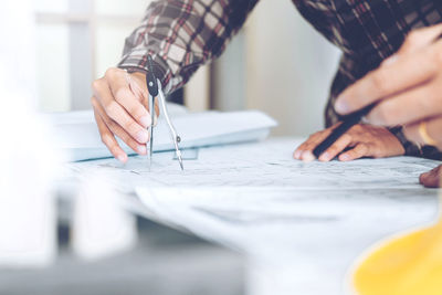 Midsection of man working at table