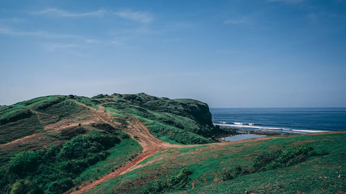 Scenic view of hill below the sea