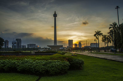 View of buildings against cloudy sky during sunset