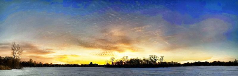 Scenic view of landscape against sky at sunset