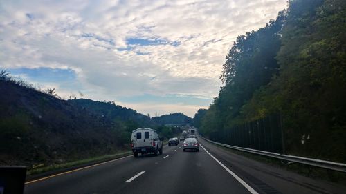 Cars on road against sky