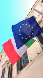 Low angle view of flags against clear sky