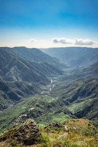 Misty mountain range covered with white mist and amazing blue sky