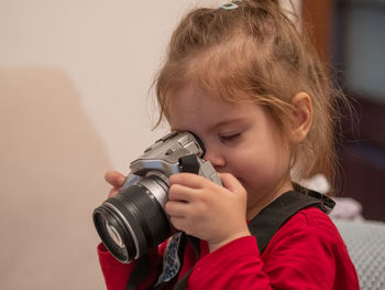 Close-up of young woman photographing with camera