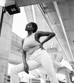 Low angle view of young woman dancing