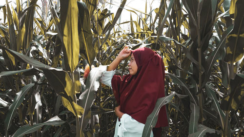 Rear view of woman standing in field