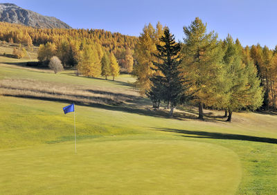 Scenic view of golf course against sky