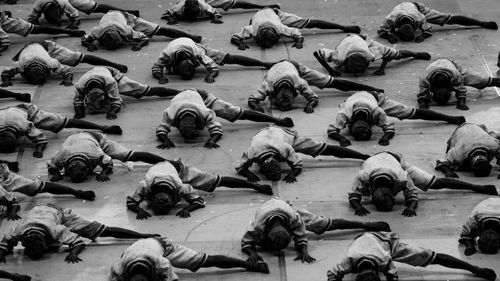 High angle view of crowd stretching legs on floor