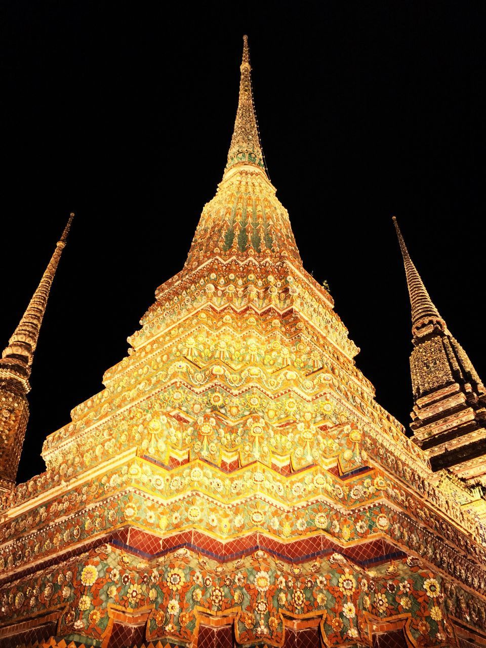 LOW ANGLE VIEW OF ILLUMINATED BUILDING AGAINST SKY