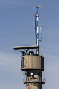 Low angle view of communications tower against sky