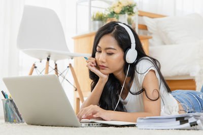 Mid adult woman using mobile phone