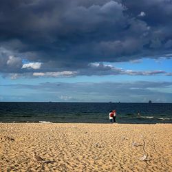 People on beach against sky