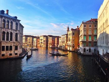 Boats in canal along buildings