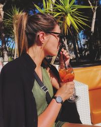 Midsection of a woman drinking glass