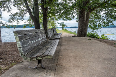 Man relaxing on bench by lake