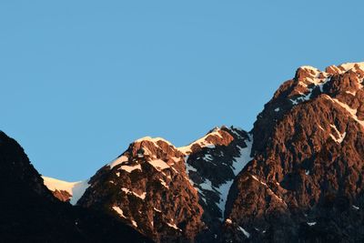 Rock formations against clear blue sky