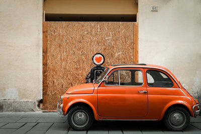 Vintage car on street against wall