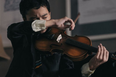 A boy in deep concentration while playing the violin