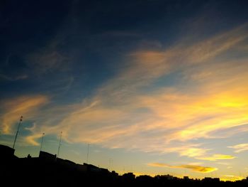 Low angle view of silhouette trees against sky