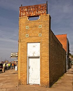 Low angle view of text on building against sky