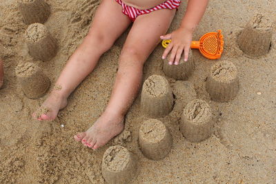 Low section of girl playing on beach