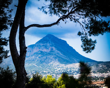 Scenic view of mountains against blue sky