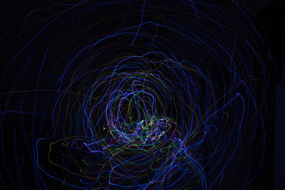 Light painting abstract colorful irregular lines or patterns on black background with long exposure.