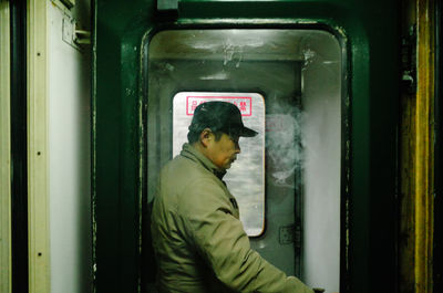 Side view of man in train