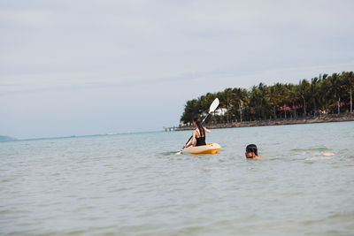 People kayaking in sea