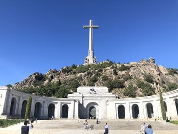 Group of people at church against clear blue sky